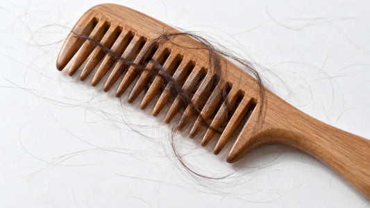 Loose hair wrapped around a wooden wide-tooth comb